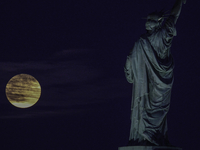 A partial lunar eclipse and supermoon occur in New York, United States, on September 17, 2024, as captured from Liberty Park in New Jersey....