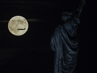 A partial lunar eclipse and supermoon occur in New York, United States, on September 17, 2024, as captured from Liberty Park in New Jersey....