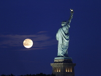 A partial lunar eclipse and supermoon occur in New York, United States, on September 17, 2024, as captured from Liberty Park in New Jersey....