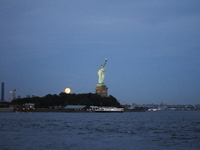 A partial lunar eclipse and supermoon occur in New York, United States, on September 17, 2024, as captured from Liberty Park in New Jersey....