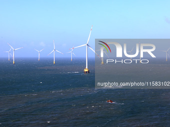 Wind turbines stand in the sea and rotate continuously at Pingtan Comprehensive Experimental Zone in Fujian, China, on September 17, 2024. (