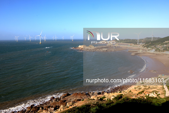 Wind turbines stand in the sea and rotate continuously at Pingtan Comprehensive Experimental Zone in Fujian, China, on September 17, 2024. 