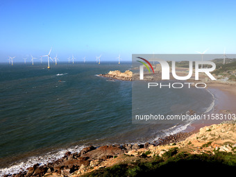 Wind turbines stand in the sea and rotate continuously at Pingtan Comprehensive Experimental Zone in Fujian, China, on September 17, 2024. (