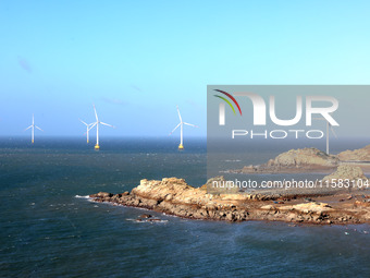 Wind turbines stand in the sea and rotate continuously at Pingtan Comprehensive Experimental Zone in Fujian, China, on September 17, 2024. (