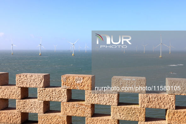 Wind turbines stand in the sea and rotate continuously at Pingtan Comprehensive Experimental Zone in Fujian, China, on September 17, 2024. 