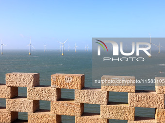 Wind turbines stand in the sea and rotate continuously at Pingtan Comprehensive Experimental Zone in Fujian, China, on September 17, 2024. (