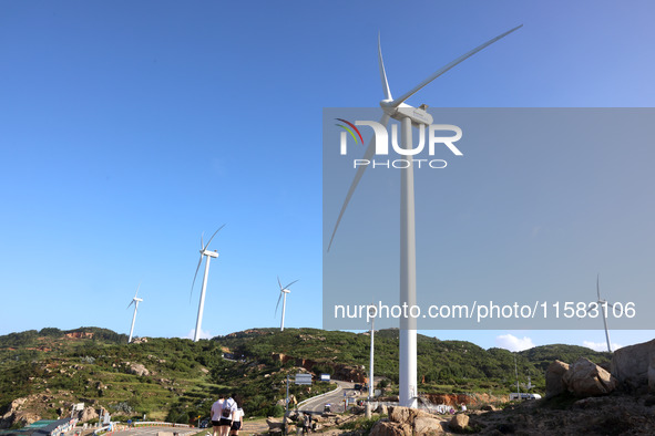 Wind turbines stand in the sea and rotate continuously at Pingtan Comprehensive Experimental Zone in Fujian, China, on September 17, 2024. 