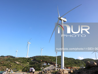 Wind turbines stand in the sea and rotate continuously at Pingtan Comprehensive Experimental Zone in Fujian, China, on September 17, 2024. (