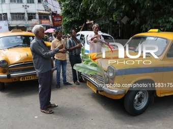 Taxi drivers perform puja on a Yakow Ambassador Taxi on Vishwakarma Puja in Kolkata, India, on September 17, 2024. The maker of India's Amba...