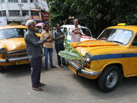 Taxi drivers perform puja on a Yakow Ambassador Taxi on Vishwakarma Puja in Kolkata, India, on September 17, 2024. The maker of India's Amba...