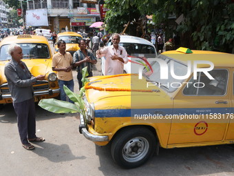 Taxi drivers perform puja on a Yakow Ambassador Taxi on Vishwakarma Puja in Kolkata, India, on September 17, 2024. The maker of India's Amba...