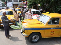 Taxi drivers perform puja on a Yakow Ambassador Taxi on Vishwakarma Puja in Kolkata, India, on September 17, 2024. The maker of India's Amba...