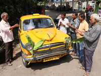 Taxi drivers perform puja on a Yakow Ambassador Taxi on Vishwakarma Puja in Kolkata, India, on September 17, 2024. The maker of India's Amba...