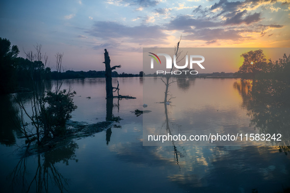 A sunset over an area covered with water after Nysa Klodzka river flooded town of Lewin Brzeski in southwestern Poland, on September 17th, 2...