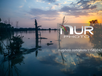 A sunset over an area covered with water after Nysa Klodzka river flooded town of Lewin Brzeski in southwestern Poland, on September 17th, 2...