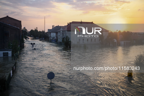 A sunset over an area covered with water after Nysa Klodzka river flooded town of Lewin Brzeski in southwestern Poland, on September 17th, 2...