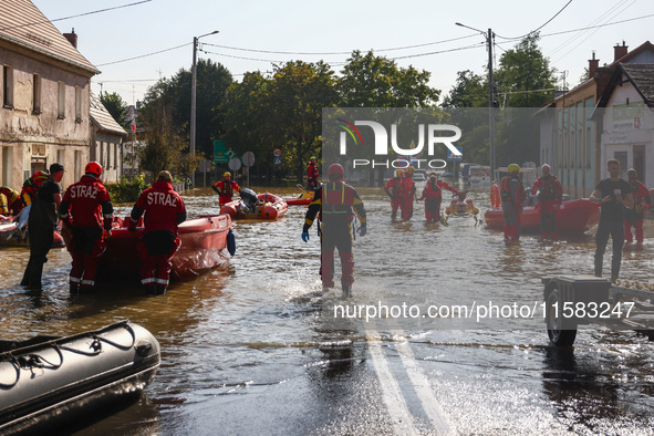 Residents are being evacuated by emergency workers after Nysa Klodzka river flooded town of Lewin Brzeski in southwestern Poland, on Septemb...