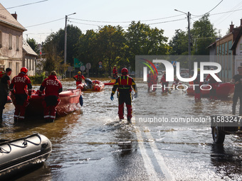 Residents are being evacuated by emergency workers after Nysa Klodzka river flooded town of Lewin Brzeski in southwestern Poland, on Septemb...