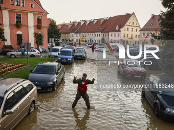 Residents are being evacuated by emergency workers after Nysa Klodzka river flooded town of Lewin Brzeski in southwestern Poland, on Septemb...