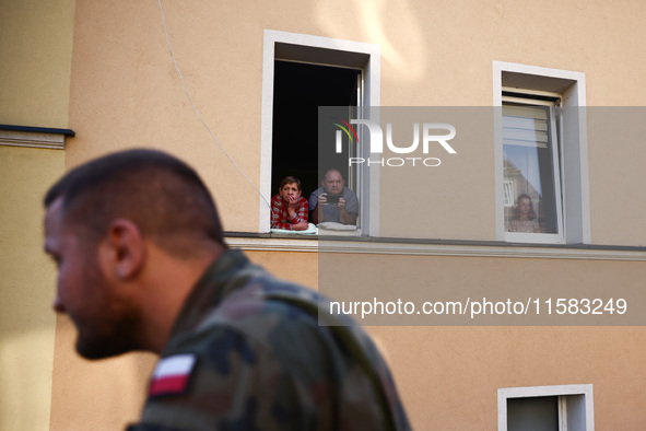 Residents watch emergency workers after Nysa Klodzka river flooded town of Lewin Brzeski in southwestern Poland, on September 17th, 2024. St...