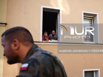 Residents watch emergency workers after Nysa Klodzka river flooded town of Lewin Brzeski in southwestern Poland, on September 17th, 2024. St...