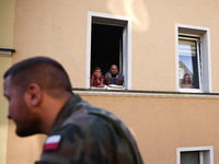 Residents watch emergency workers after Nysa Klodzka river flooded town of Lewin Brzeski in southwestern Poland, on September 17th, 2024. St...