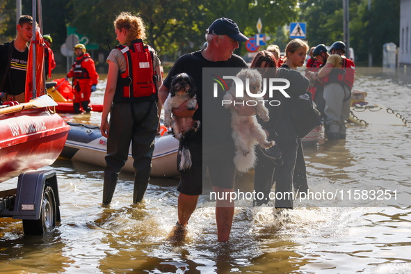 Residents are being evacuated by emergency workers after Nysa Klodzka river flooded town of Lewin Brzeski in southwestern Poland, on Septemb...