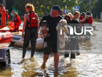 Residents are being evacuated by emergency workers after Nysa Klodzka river flooded town of Lewin Brzeski in southwestern Poland, on Septemb...