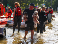 Residents are being evacuated by emergency workers after Nysa Klodzka river flooded town of Lewin Brzeski in southwestern Poland, on Septemb...