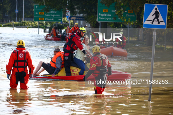 Residents are being evacuated by emergency workers after Nysa Klodzka river flooded town of Lewin Brzeski in southwestern Poland, on Septemb...