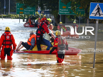 Residents are being evacuated by emergency workers after Nysa Klodzka river flooded town of Lewin Brzeski in southwestern Poland, on Septemb...