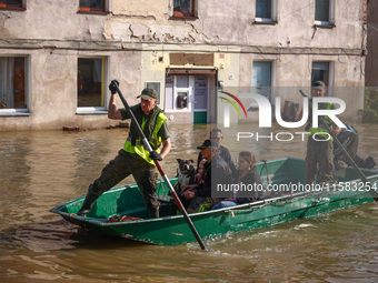 Residents are being evacuated by emergency workers after Nysa Klodzka river flooded town of Lewin Brzeski in southwestern Poland, on Septemb...