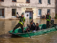 Residents are being evacuated by emergency workers after Nysa Klodzka river flooded town of Lewin Brzeski in southwestern Poland, on Septemb...