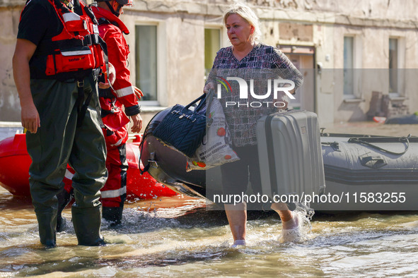 Residents are being evacuated by emergency workers after Nysa Klodzka river flooded town of Lewin Brzeski in southwestern Poland, on Septemb...