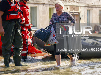 Residents are being evacuated by emergency workers after Nysa Klodzka river flooded town of Lewin Brzeski in southwestern Poland, on Septemb...