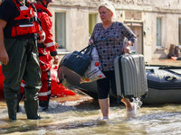 Residents are being evacuated by emergency workers after Nysa Klodzka river flooded town of Lewin Brzeski in southwestern Poland, on Septemb...