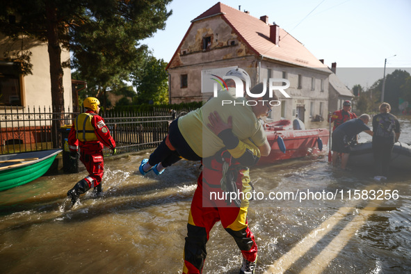 Residents are being evacuated by emergency workers after Nysa Klodzka river flooded town of Lewin Brzeski in southwestern Poland, on Septemb...