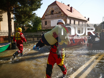 Residents are being evacuated by emergency workers after Nysa Klodzka river flooded town of Lewin Brzeski in southwestern Poland, on Septemb...