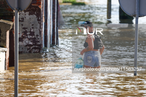 A resident is seen walking in a water after after Nysa Klodzka river flooded town of Lewin Brzeski in southwestern Poland, on September 17th...