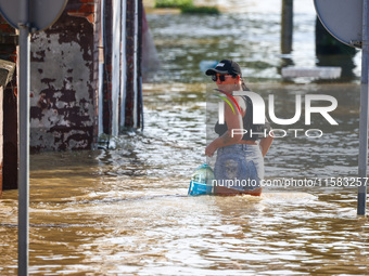 A resident is seen walking in a water after after Nysa Klodzka river flooded town of Lewin Brzeski in southwestern Poland, on September 17th...