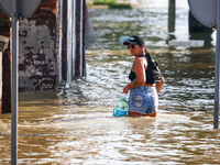 A resident is seen walking in a water after after Nysa Klodzka river flooded town of Lewin Brzeski in southwestern Poland, on September 17th...