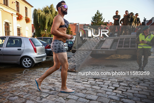 A resident is walking in the city after Nysa Klodzka river flooded town of Lewin Brzeski in southwestern Poland, on September 17th, 2024. St...