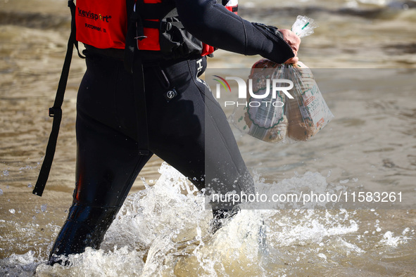 An emergency workers carries bread for residents after Nysa Klodzka river flooded town of Lewin Brzeski in southwestern Poland, on September...