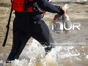 An emergency workers carries bread for residents after Nysa Klodzka river flooded town of Lewin Brzeski in southwestern Poland, on September...