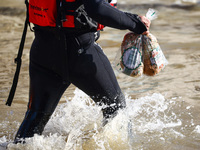 An emergency workers carries bread for residents after Nysa Klodzka river flooded town of Lewin Brzeski in southwestern Poland, on September...