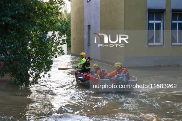 Emergency workers are swimming on a boat after Nysa Klodzka river flooded town of Lewin Brzeski in southwestern Poland, on September 17th, 2...