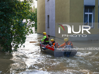 Emergency workers are swimming on a boat after Nysa Klodzka river flooded town of Lewin Brzeski in southwestern Poland, on September 17th, 2...