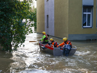 Emergency workers are swimming on a boat after Nysa Klodzka river flooded town of Lewin Brzeski in southwestern Poland, on September 17th, 2...