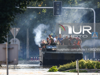 Residents are being evacuated on a military amphibious vehicle by emergency workers after Nysa Klodzka river flooded town of Lewin Brzeski i...