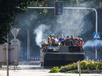 Residents are being evacuated on a military amphibious vehicle by emergency workers after Nysa Klodzka river flooded town of Lewin Brzeski i...